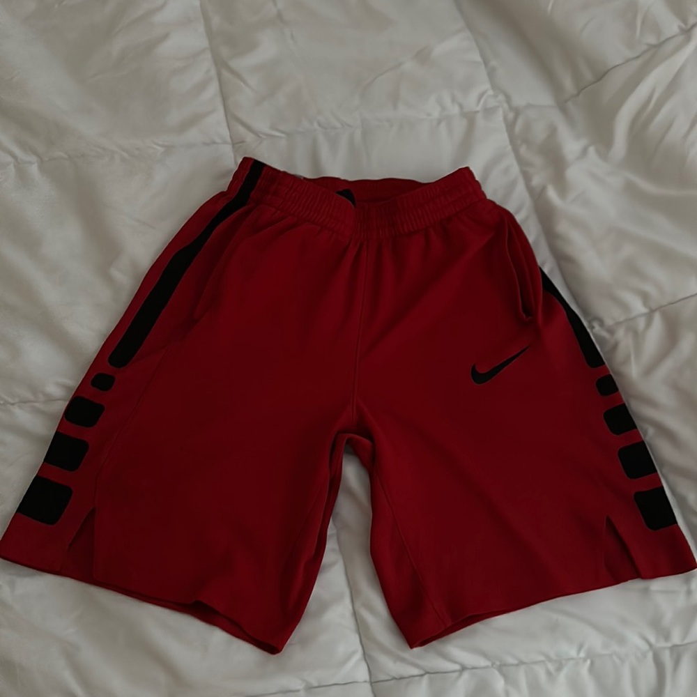 Red Nike elite shorts with black stripes down the side.